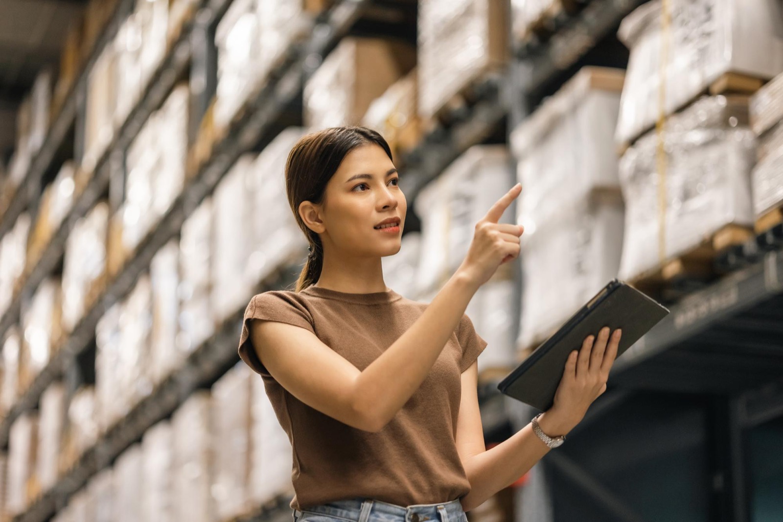 Sourcing specialist checking warehouse stock on a tablet